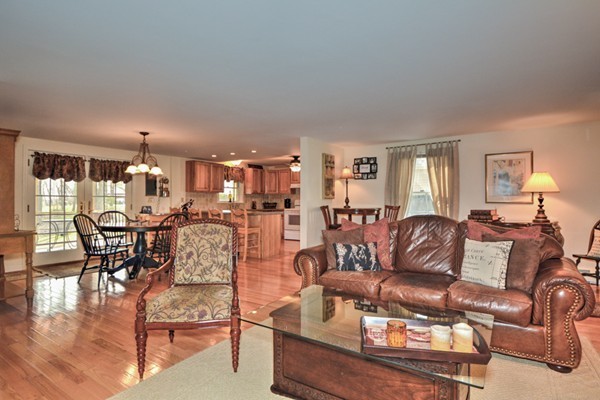 12 Williams Road Sturbridge, MA 01566 - Photo 8 of 30 a living room with furniture and a dining table with kitchen view