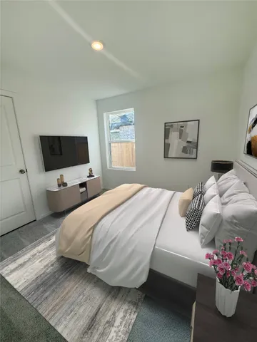 a bedroom with a bed and a flat screen tv