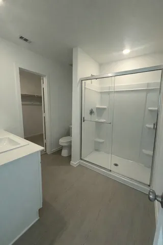 a bathroom with a shower and a toilet