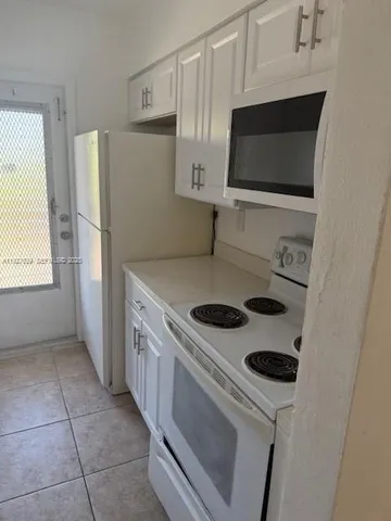 a kitchen with a stove and a microwave