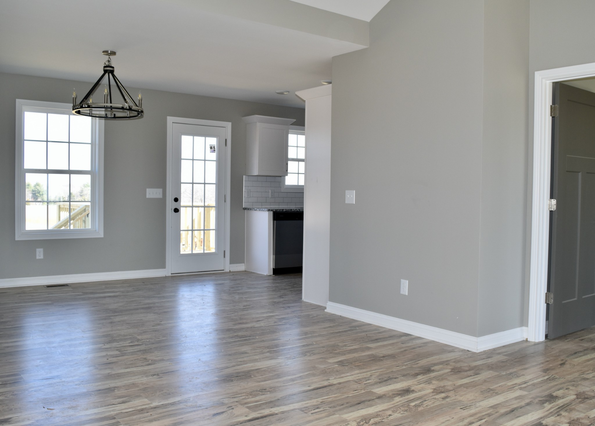 459 James Whitefield Road Bethpage, TN 37022 - Photo 3 of 16 an empty room with wooden floor chandelier and windows