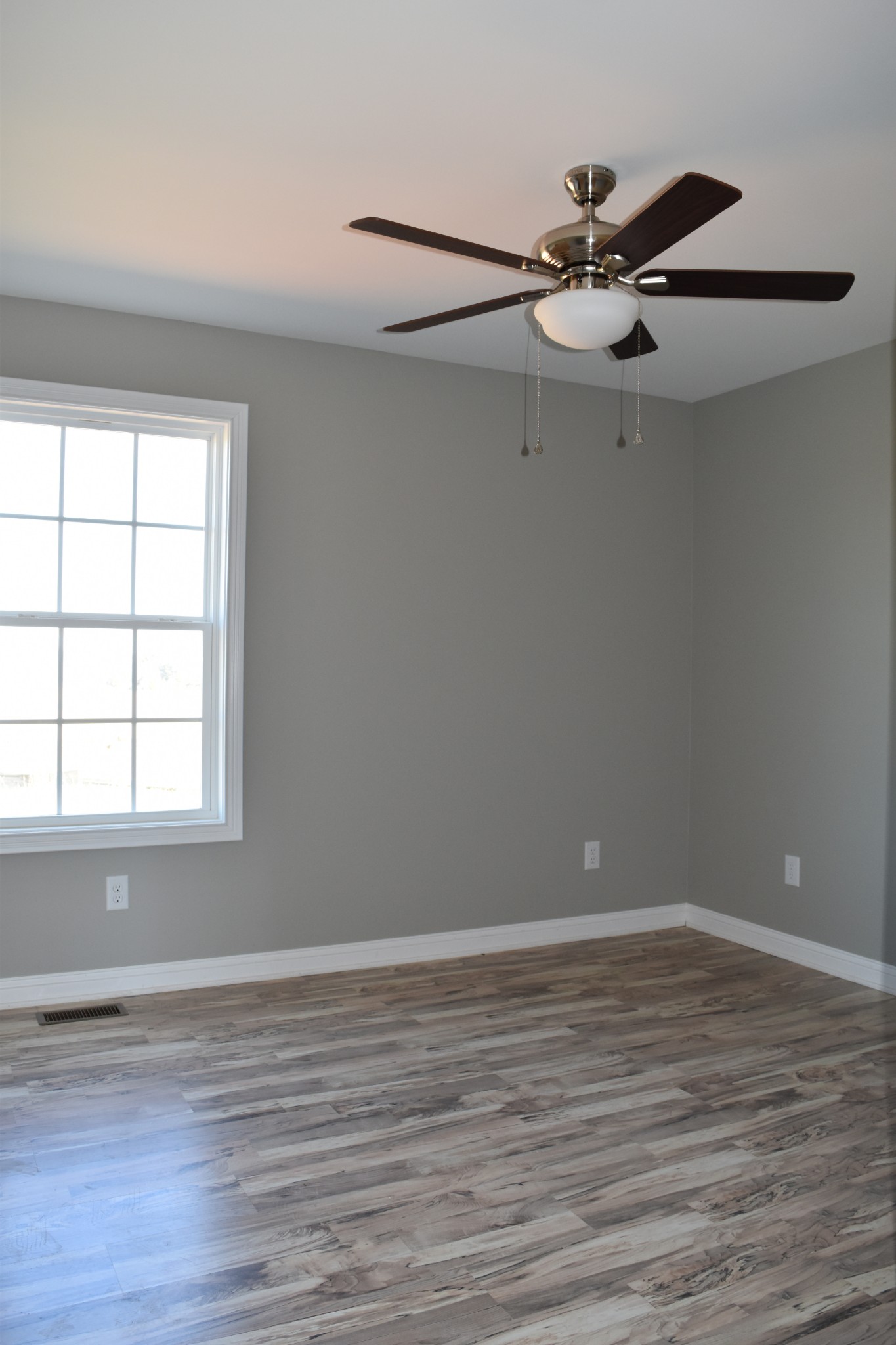 459 James Whitefield Road Bethpage, TN 37022 - Photo 10 of 16 a view of an empty room with wooden floor and a window