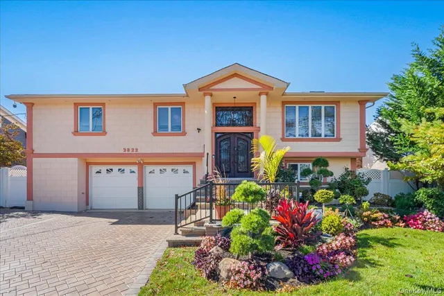 a front view of a house with a yard and a fence