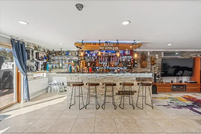 a living room with lots of furniture and gym equipment