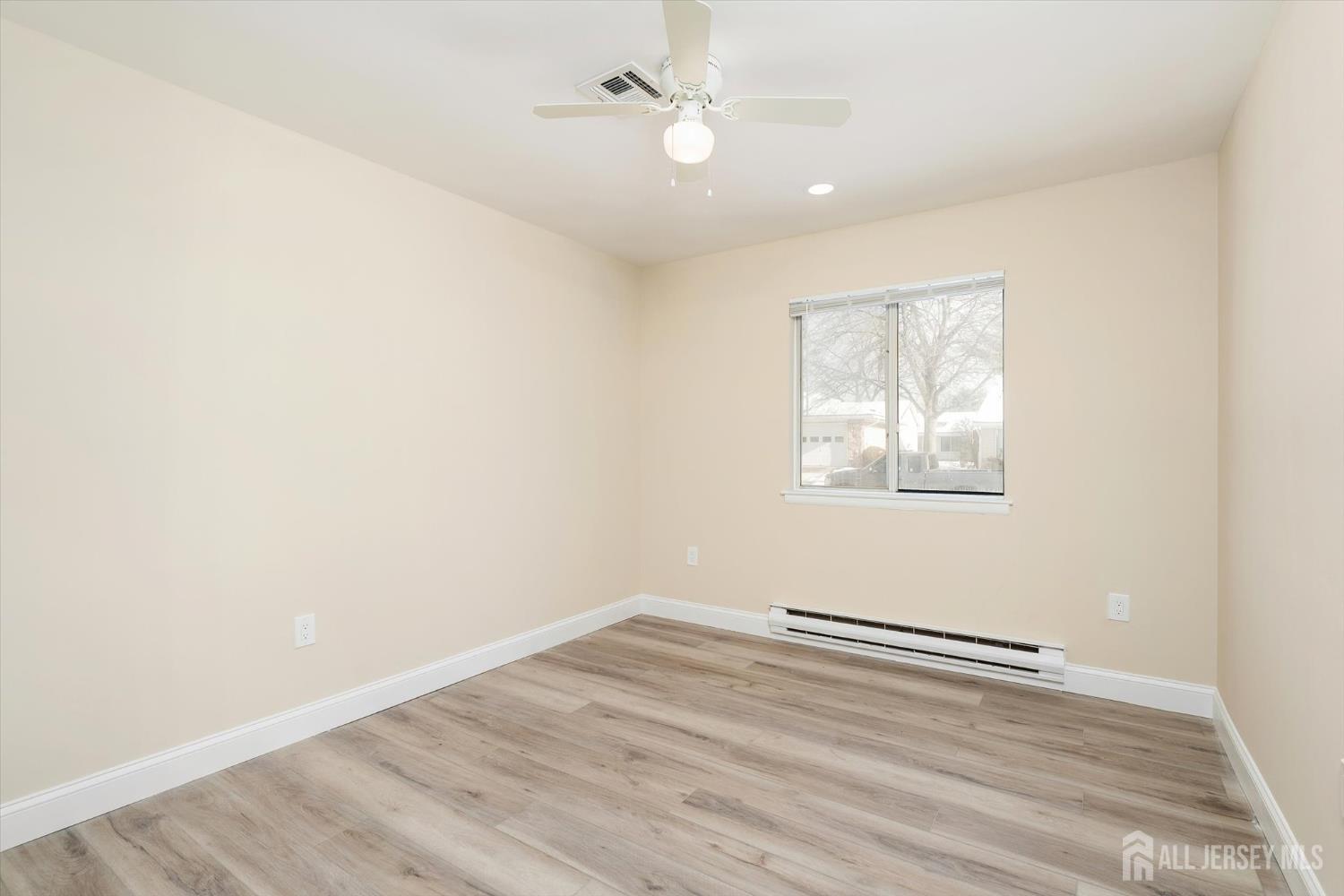 769A Marlton Road, Unit B Monroe Township, NJ 08831 - Photo 21 of 24 an empty room with wooden floor and ceiling fan
