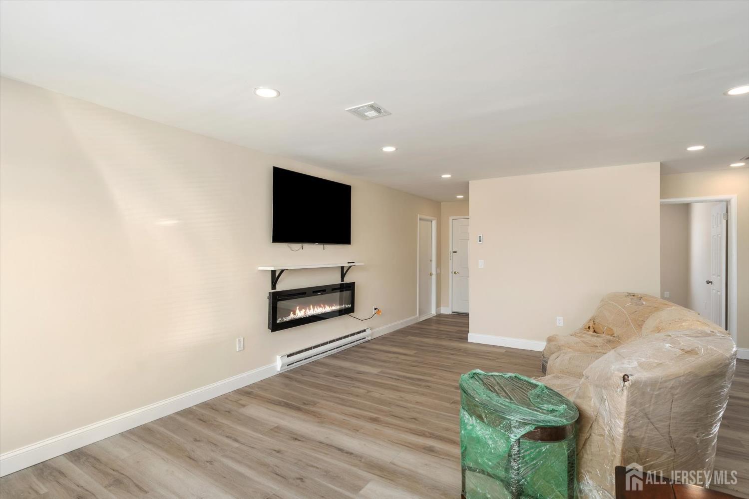 769A Marlton Road, Unit B Monroe Township, NJ 08831 - Photo 5 of 24 a living room with furniture and a flat screen tv