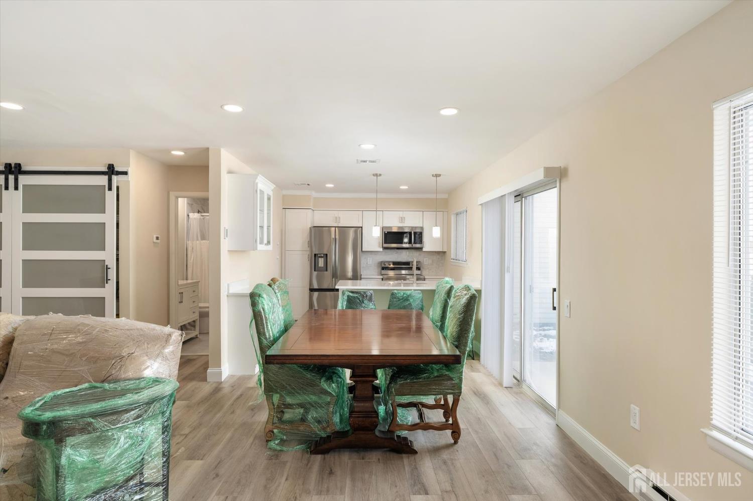 769A Marlton Road, Unit B Monroe Township, NJ 08831 - Photo 6 of 24 a view of a dining room with furniture and wooden floor