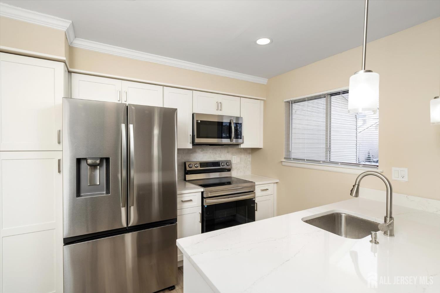 769A Marlton Road, Unit B Monroe Township, NJ 08831 - Photo 10 of 24 a kitchen with granite countertop stainless steel appliances a refrigerator sink and microwave