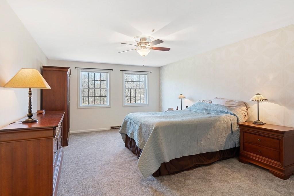 1 Fairview Drive Westford, MA 01886 - Photo 23 of 42 a bedroom with a bed and a chandelier