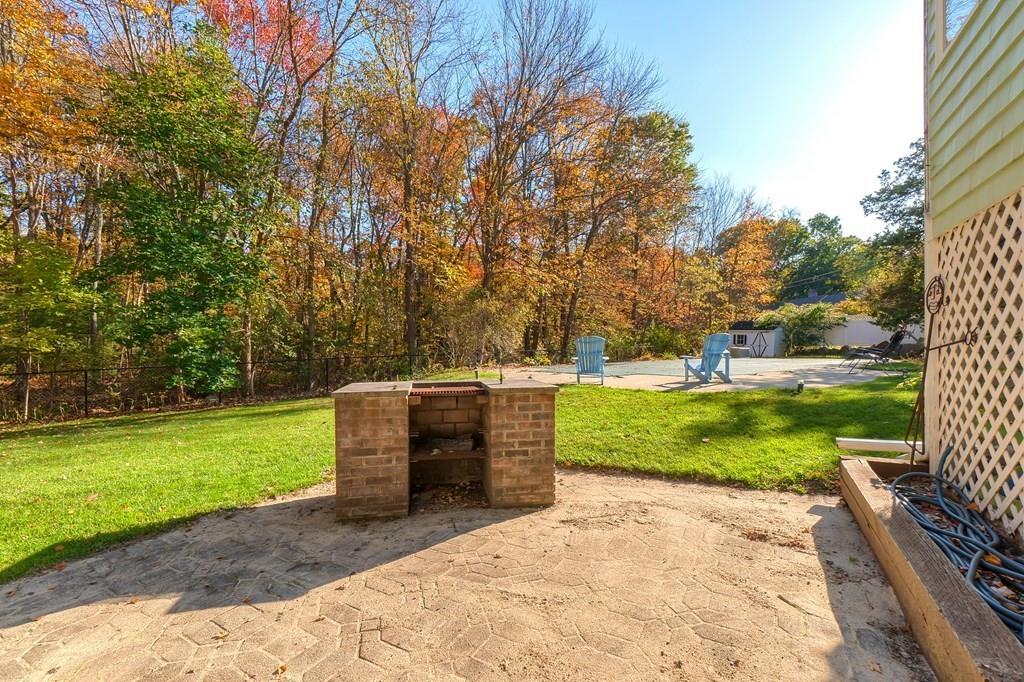 1 Fairview Drive Westford, MA 01886 - Photo 40 of 42 a backyard of a house with a yard and potted plants
