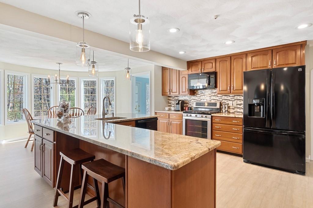 1 Fairview Drive Westford, MA 01886 - Photo 10 of 42 a kitchen with stainless steel appliances kitchen island granite countertop a kitchen island hardwood floor and a sink