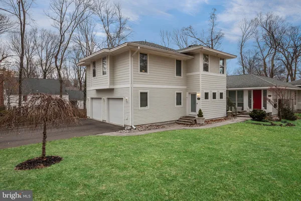 a view of a house with a yard and sitting area