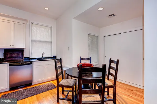 a view of a dining room with furniture and wooden floor