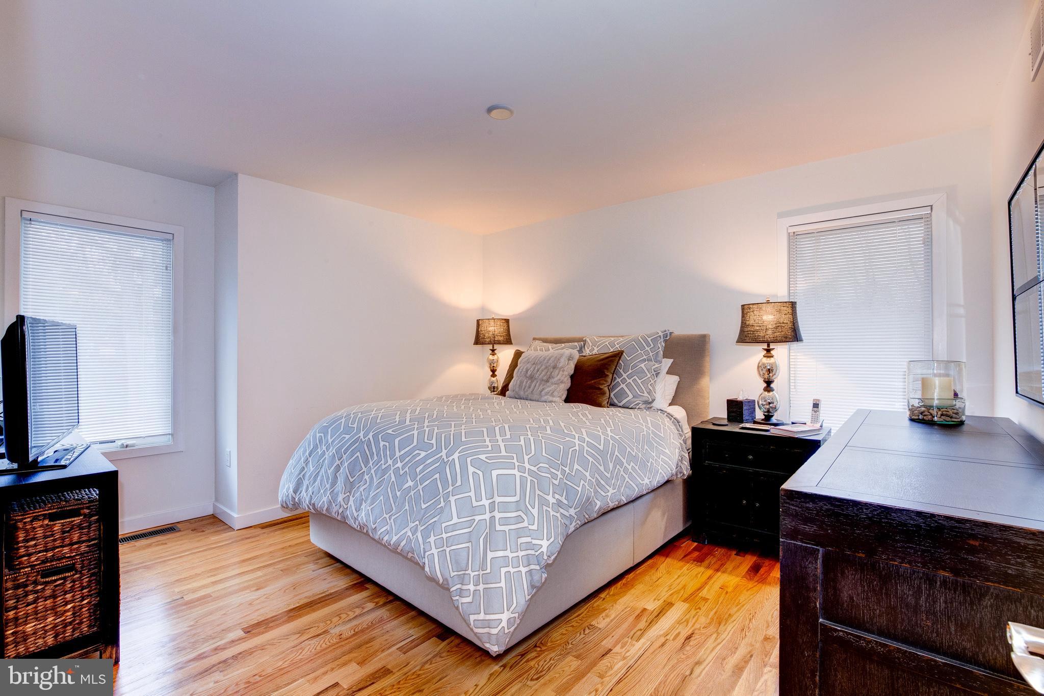 387 A Riverside Drive Princeton, NJ 08540 - Photo 16 of 23 a bedroom with a bed and a flat tv screen on a dresser