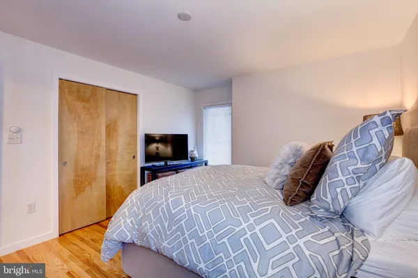 a bedroom with a bed and a flat screen tv