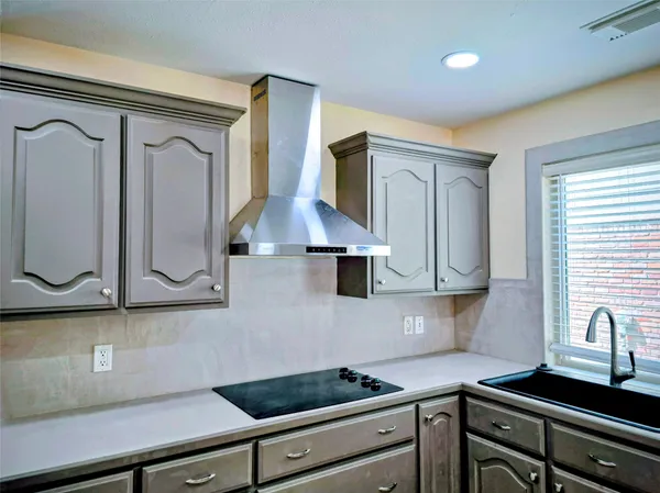 a kitchen with stainless steel appliances a sink stove and cabinets