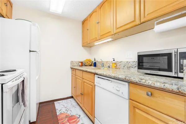 a kitchen with a sink a stove and a refrigerator