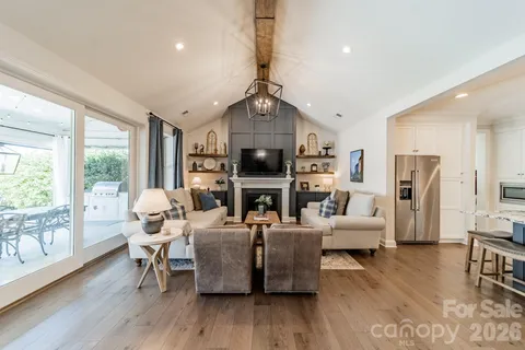a living room with fireplace furniture and a wooden floor