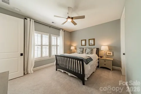 a spacious bedroom with a bed and a window
