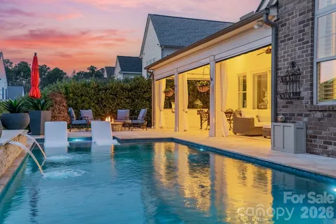 a swimming pool with outdoor seating and yard