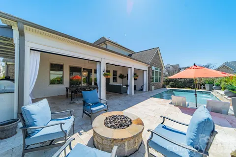 a view of a patio with a table and chairs under an umbrella