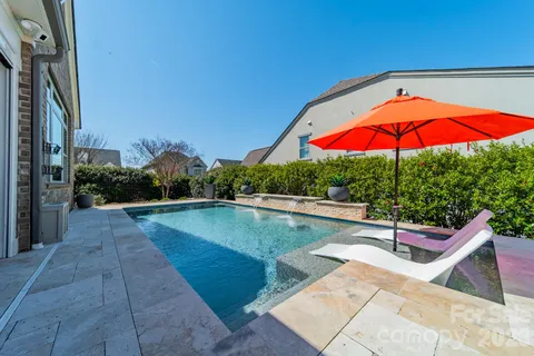an outdoor space with pool and furniture