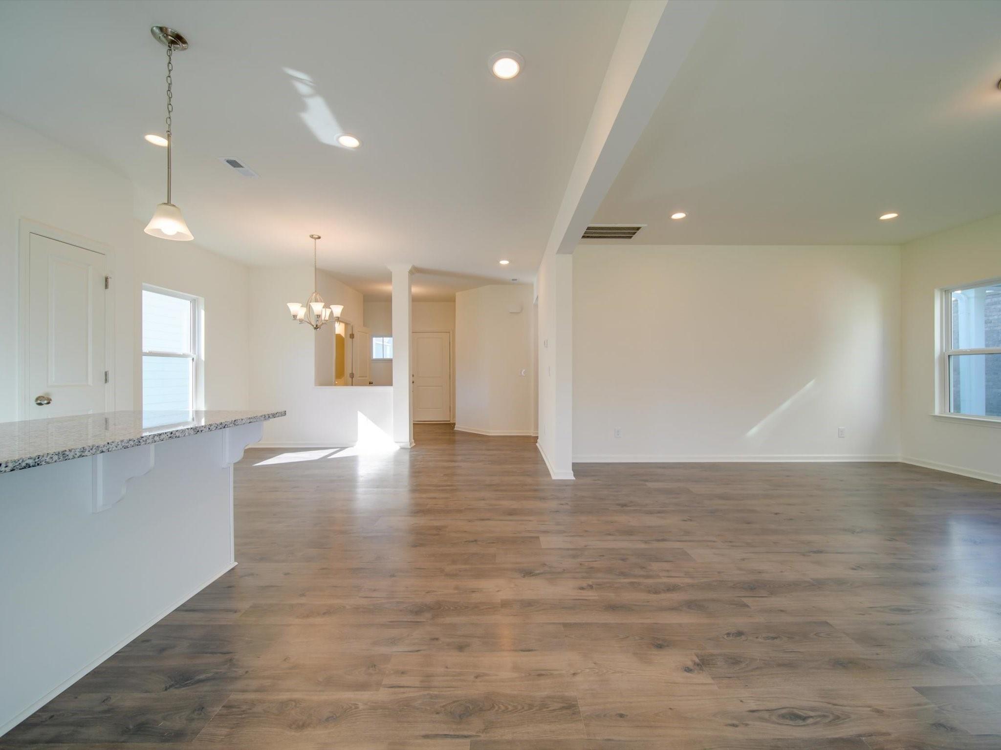 1172 Scotch Meadows Loop Monroe, NC 28110 - Photo 13 of 44 a view of an empty room with wooden floor
