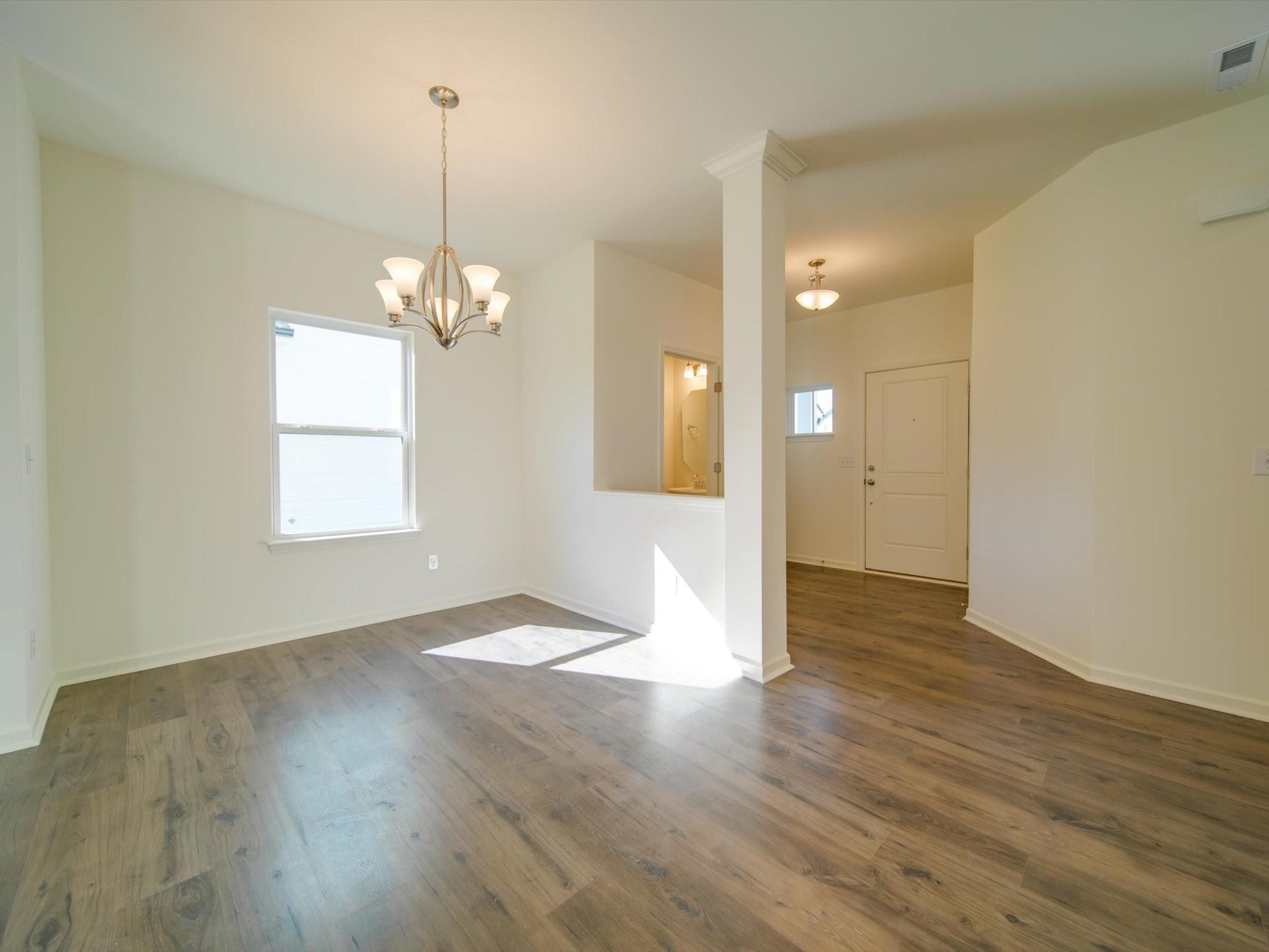 1172 Scotch Meadows Loop Monroe, NC 28110 - Photo 14 of 44 a view of a room with wooden floor and chandelier