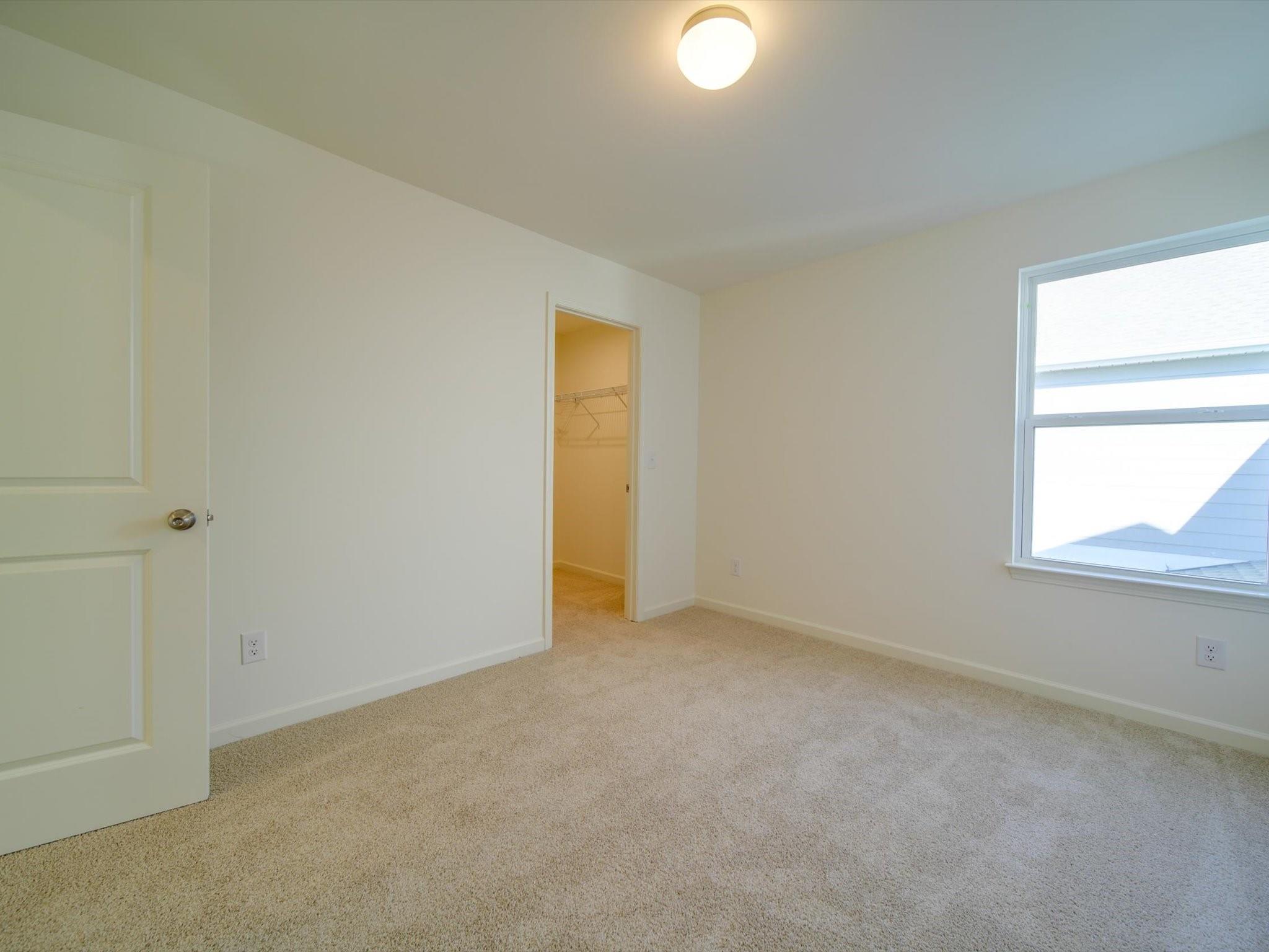 1172 Scotch Meadows Loop Monroe, NC 28110 - Photo 19 of 44 an empty room with a window