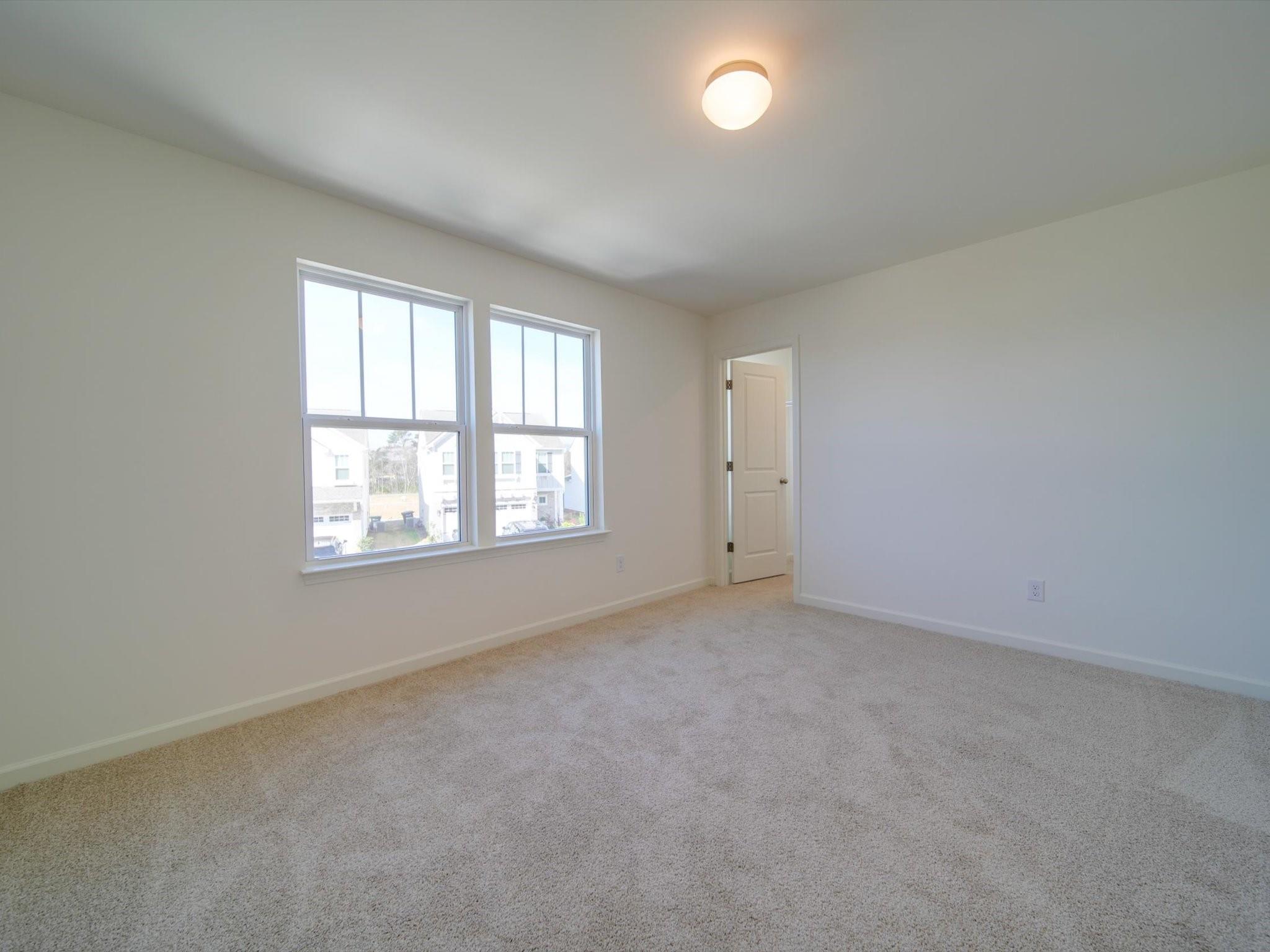 1172 Scotch Meadows Loop Monroe, NC 28110 - Photo 29 of 44 an empty room with windows