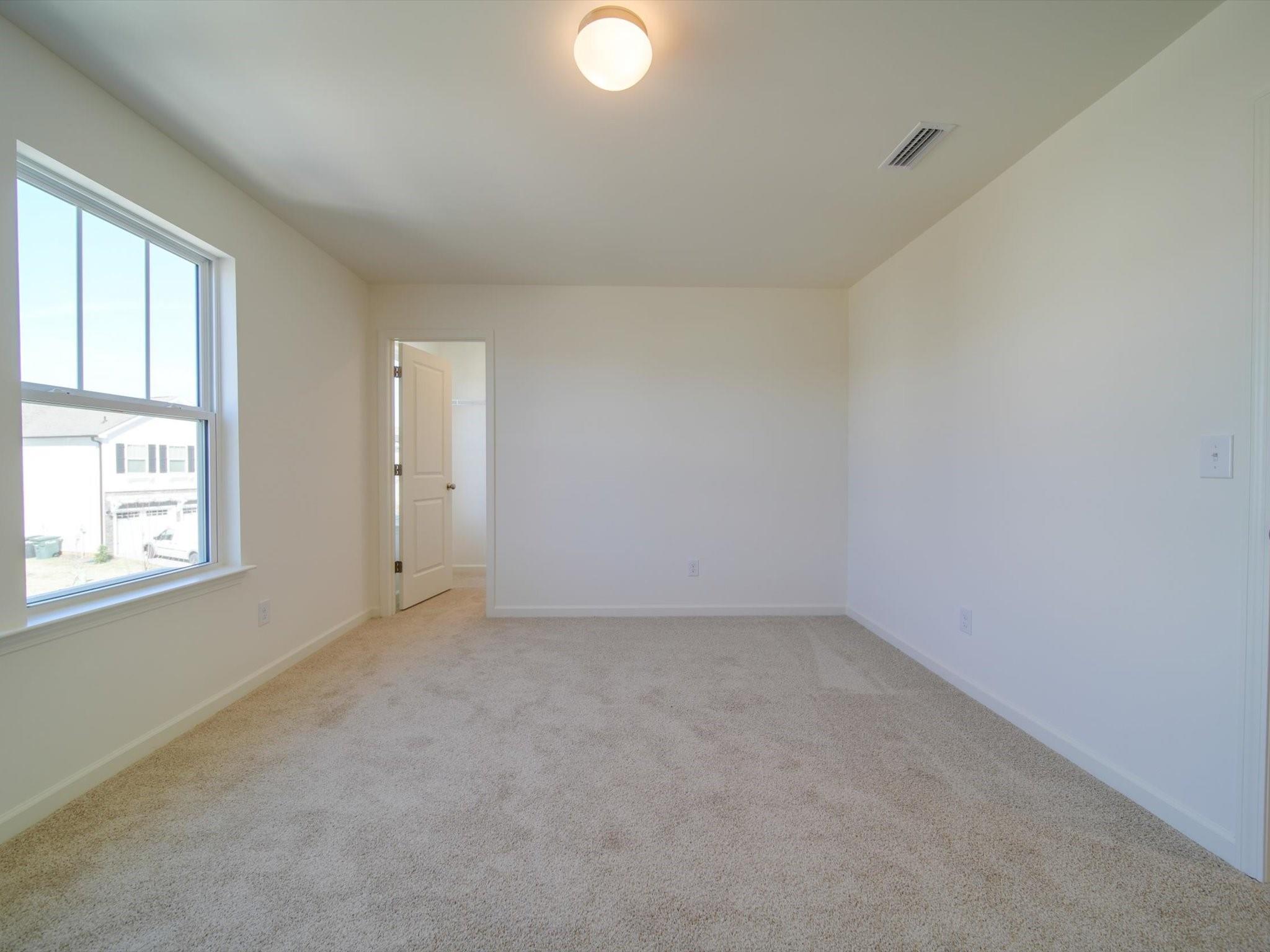 1172 Scotch Meadows Loop Monroe, NC 28110 - Photo 30 of 44 an empty room with windows