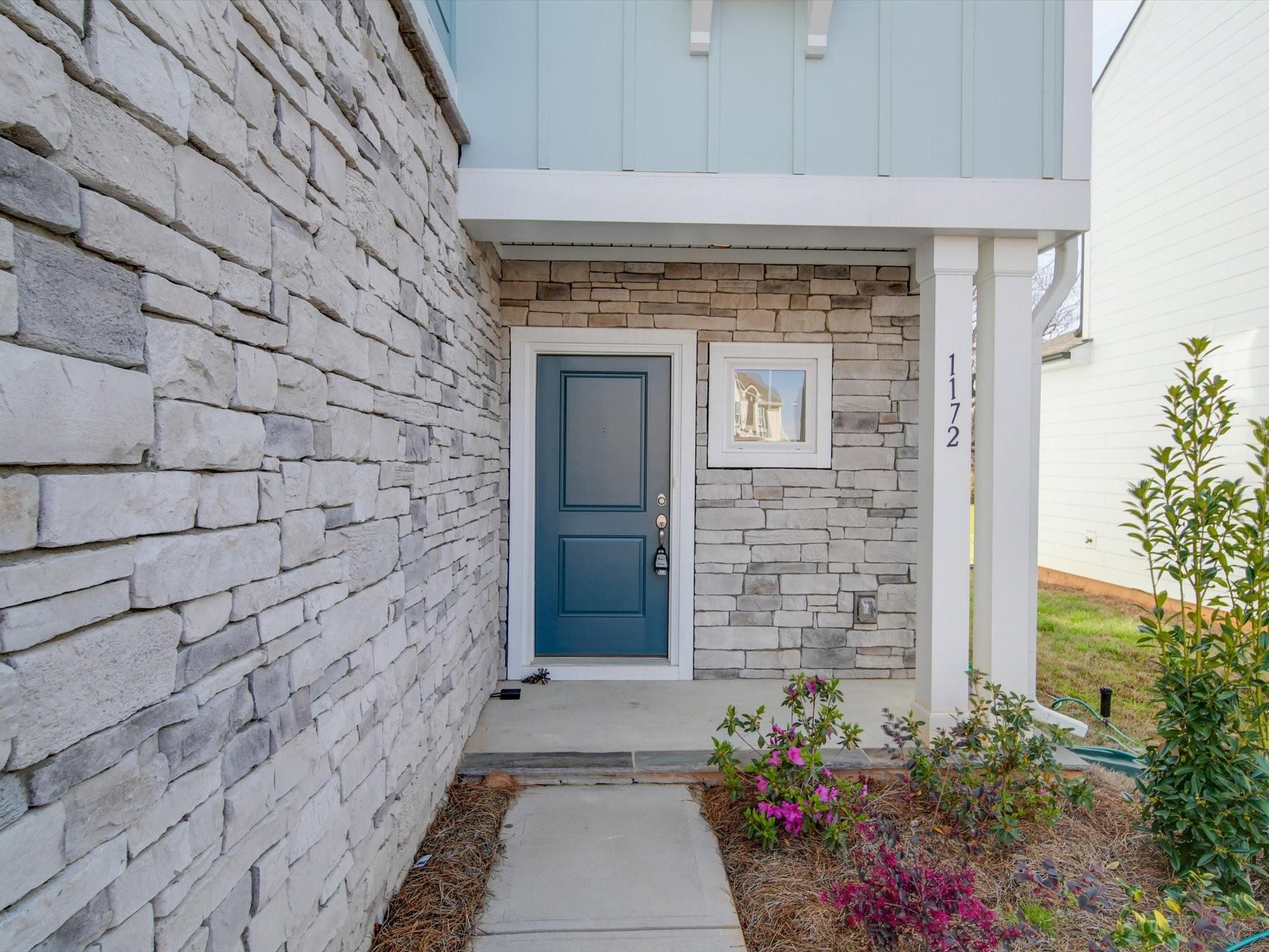 1172 Scotch Meadows Loop Monroe, NC 28110 - Photo 3 of 44 a front view of a house with a garden
