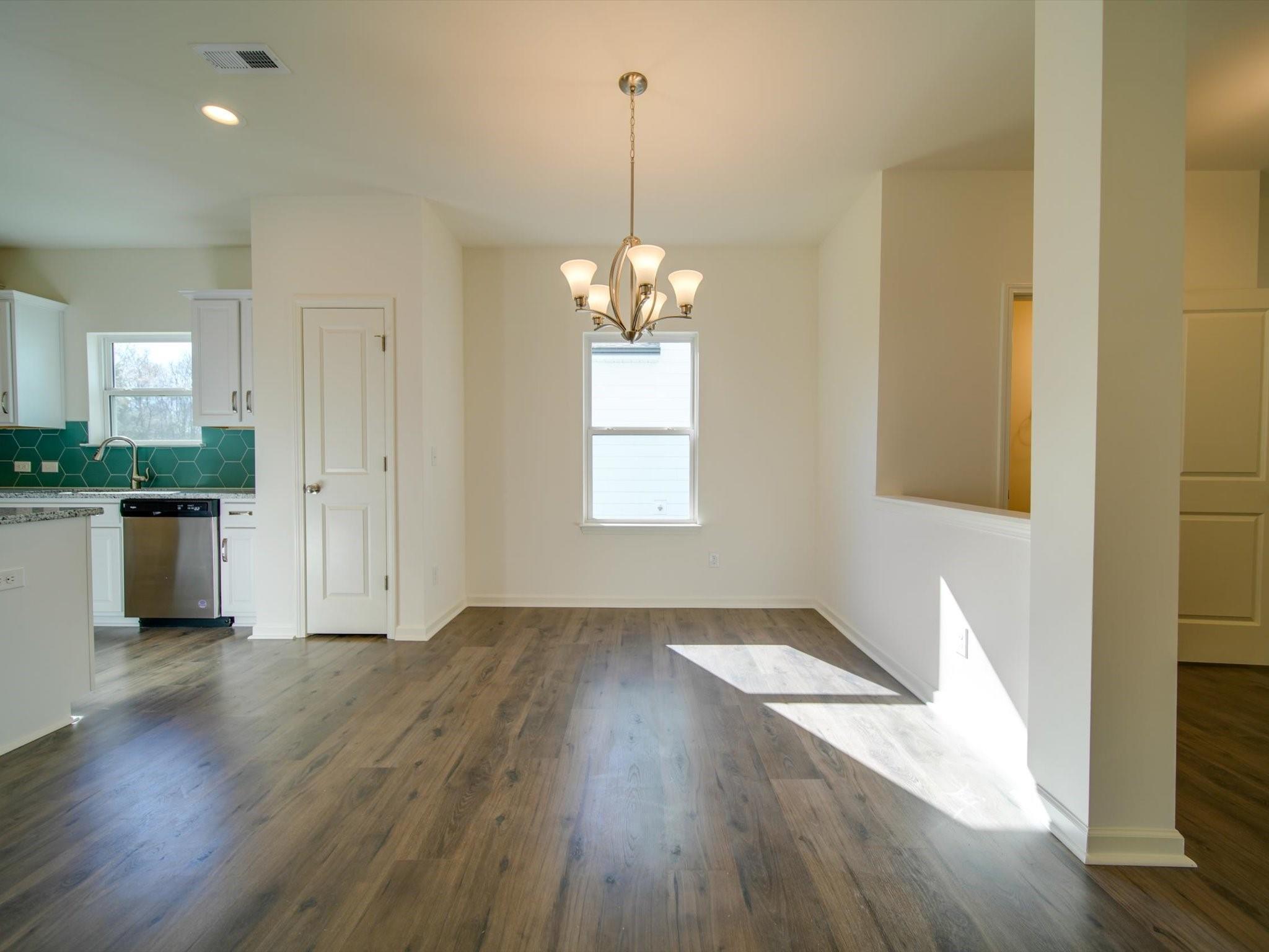 1172 Scotch Meadows Loop Monroe, NC 28110 - Photo 6 of 44 an empty room with wooden floor and windows