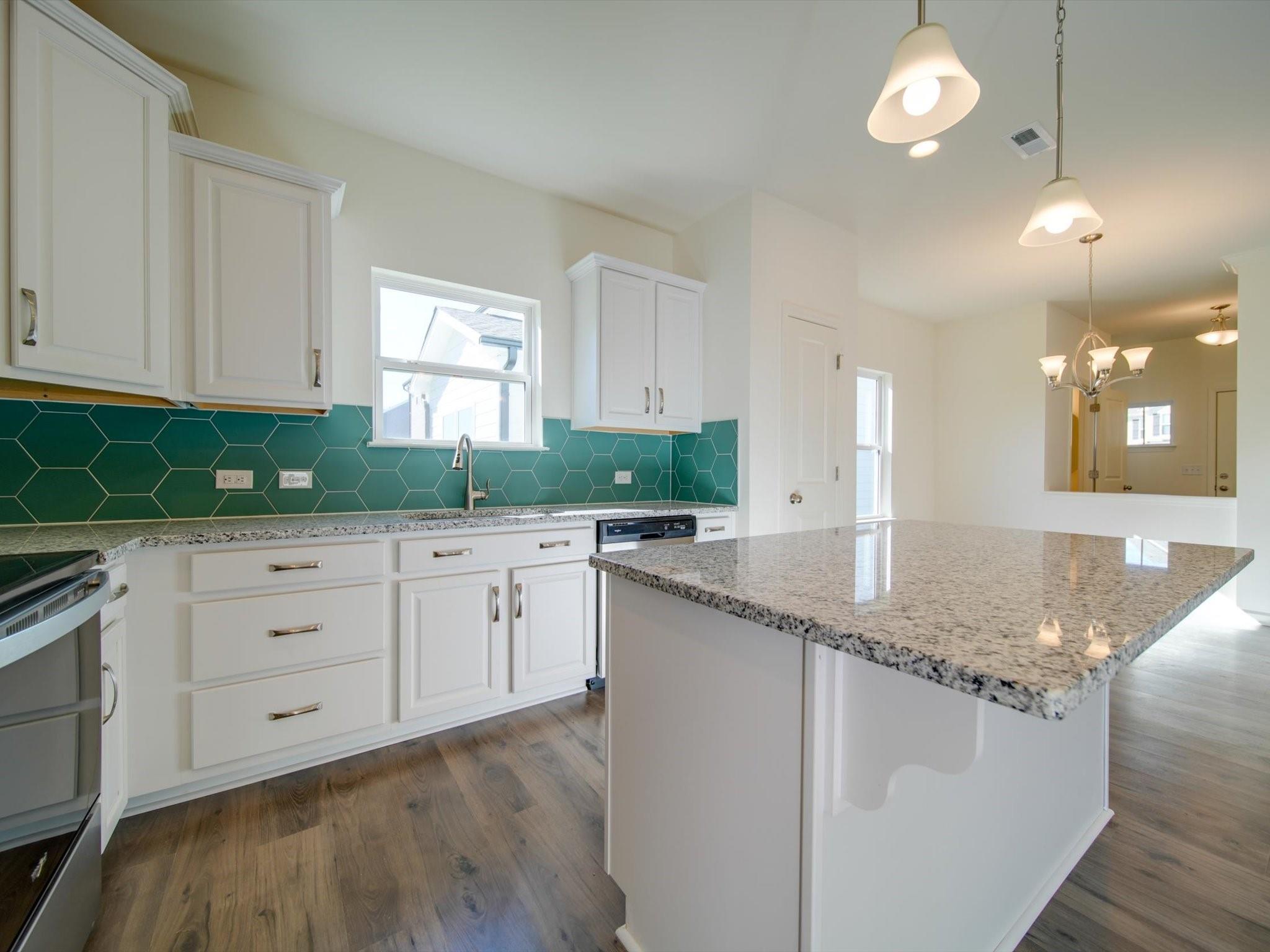 1172 Scotch Meadows Loop Monroe, NC 28110 - Photo 7 of 44 a kitchen with granite countertop white cabinets white appliances and a sink