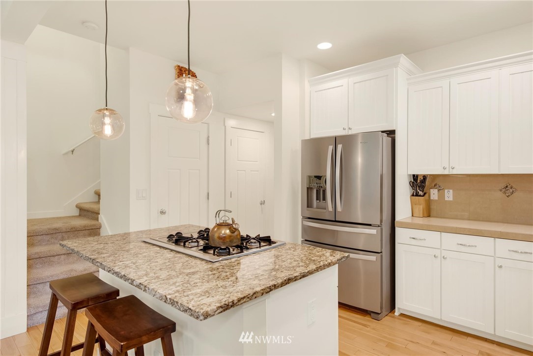 16203 41st Drive Southeast Bothell, WA 98012 - Photo 4 of 20 a kitchen with stainless steel appliances granite countertop a sink refrigerator and cabinets