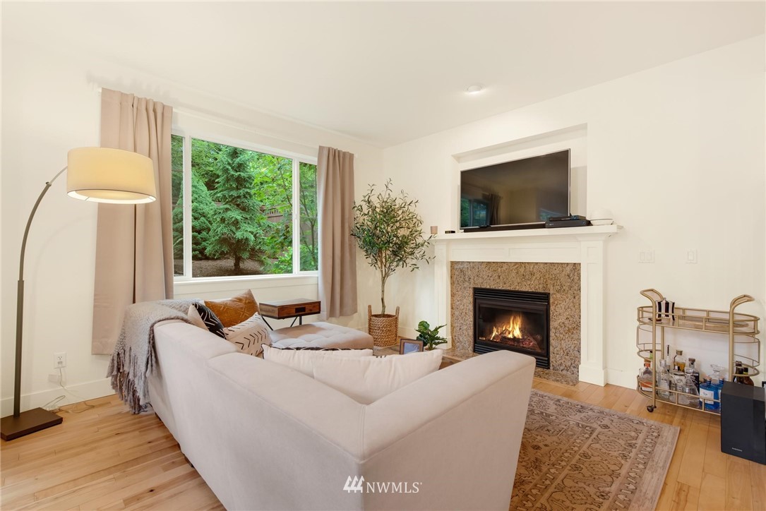 16203 41st Drive Southeast Bothell, WA 98012 - Photo 6 of 20 a living room with furniture a fireplace and a flat screen tv