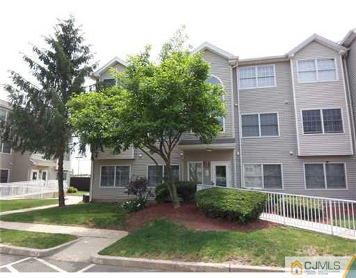 a front view of a house with a garden and deck