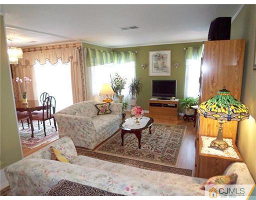 1219 Edpas Road New Brunswick, NJ 08901 - Photo 2 of 14 a living room with furniture and a flat screen tv