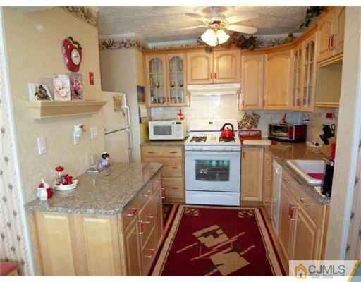 1219 Edpas Road New Brunswick, NJ 08901 - Photo 5 of 14 a kitchen with granite countertop a sink stove and cabinets