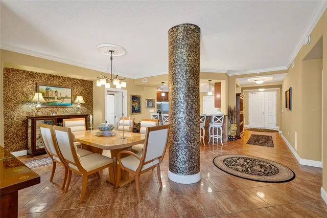 a view of a a dining room with furniture window and wooden floor