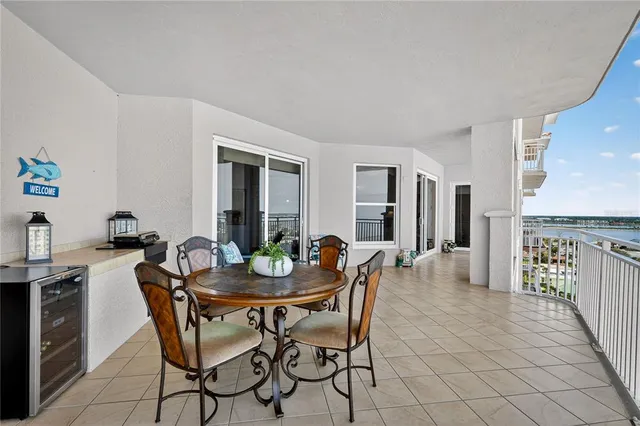 a kitchen with granite countertop furniture a stove a dining table and chairs