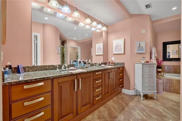 a bathroom with a tub sink and mirror