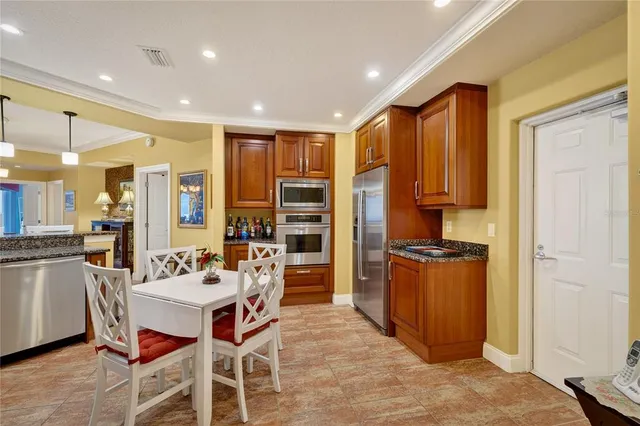a kitchen with stainless steel appliances kitchen island granite countertop a sink and cabinets