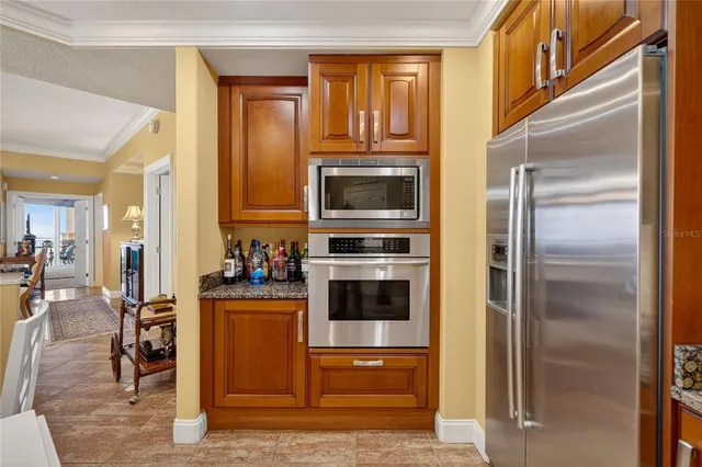 a kitchen with granite countertop lots of counter top space and living room