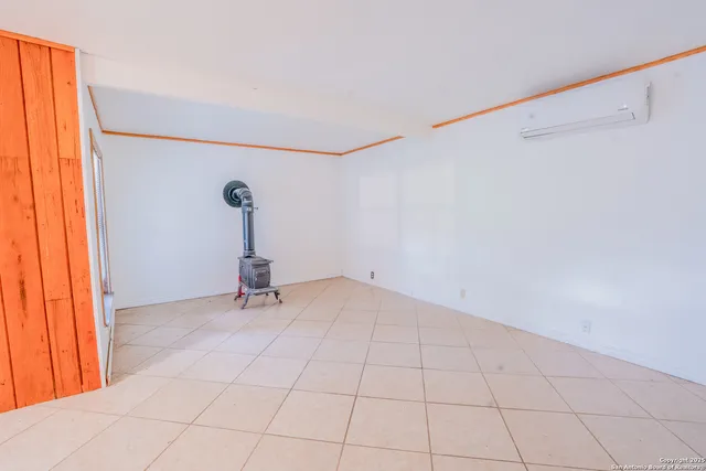 a view of a room with a window and ceiling fan