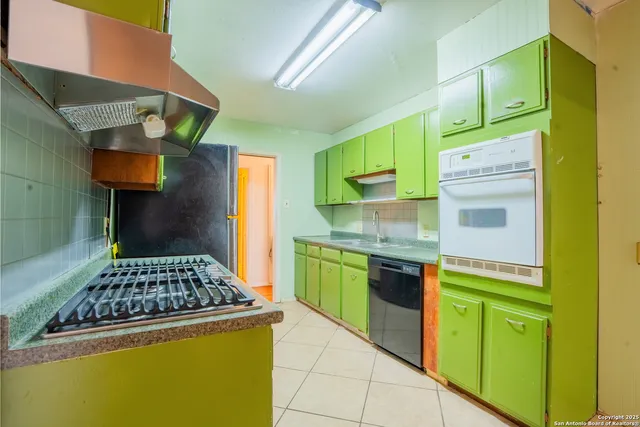 a kitchen with stainless steel appliances granite countertop a stove and a refrigerator