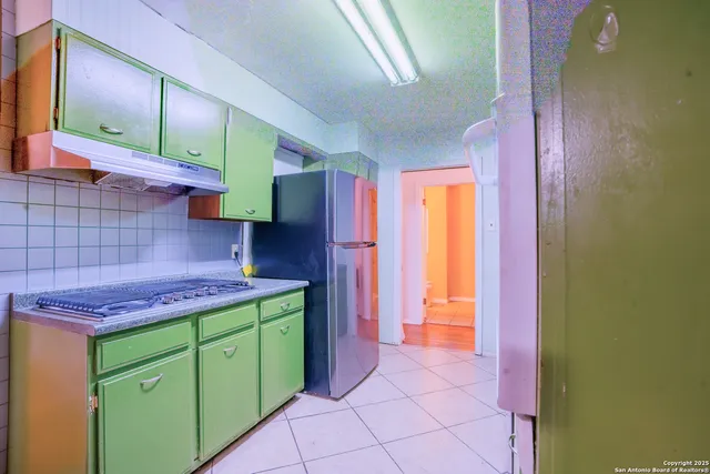 a kitchen with stainless steel appliances a stove a sink and a microwave