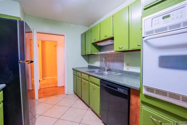 a kitchen with stainless steel appliances a sink stove and cabinets