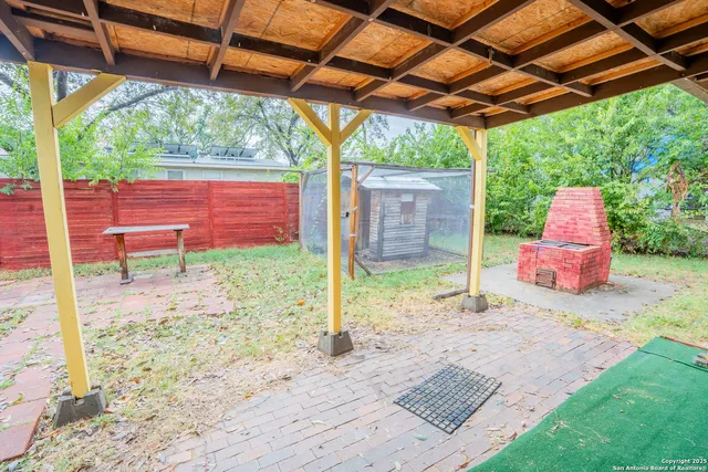 a backyard of a house with table and chairs