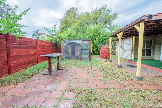 a backyard of a house with table and chairs